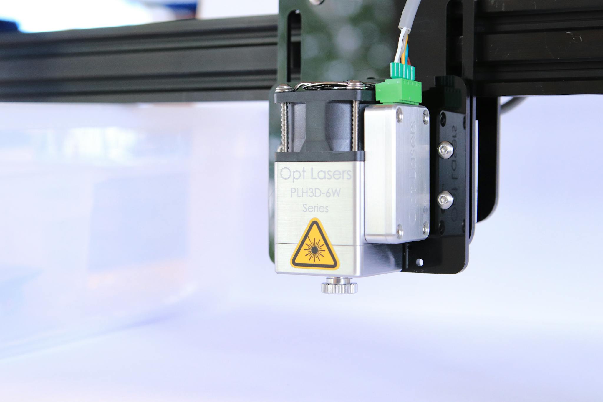 High-quality image of a laser engraving machine head, showcasing its components and precision.